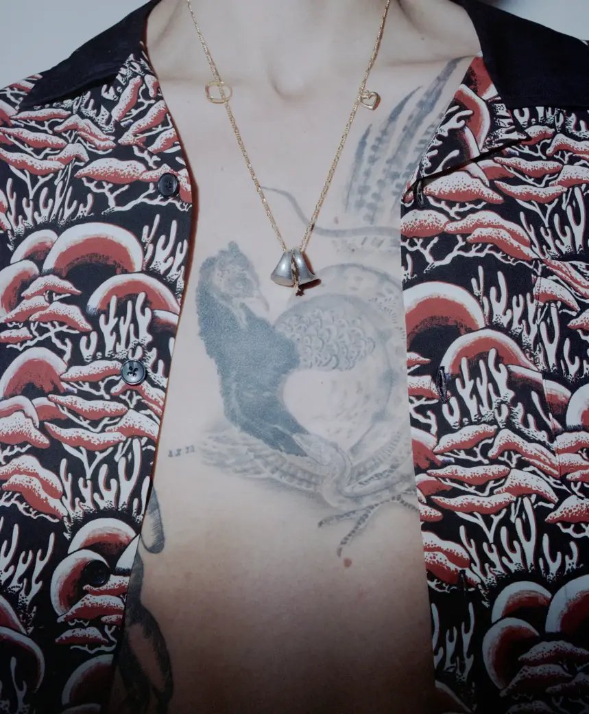 Person wearing a necklace with two rings.