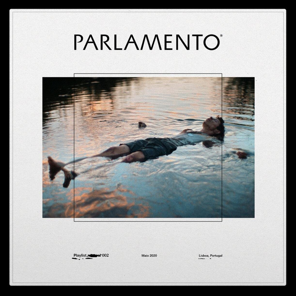 A person floats on their back in calm water at sunset, surrounded by a serene, reflective surface.