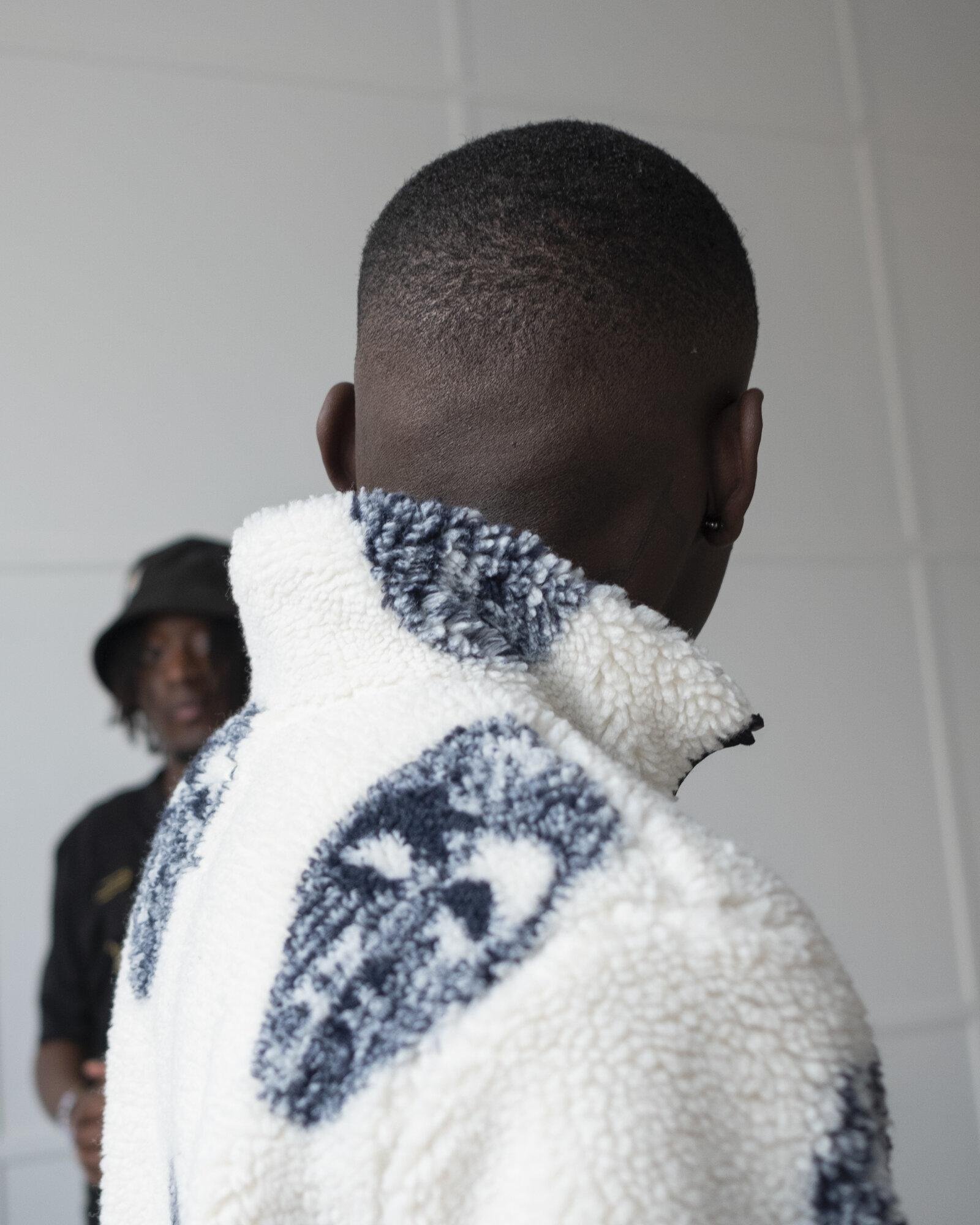 Visual Instalment 4 photo with a model from the back.