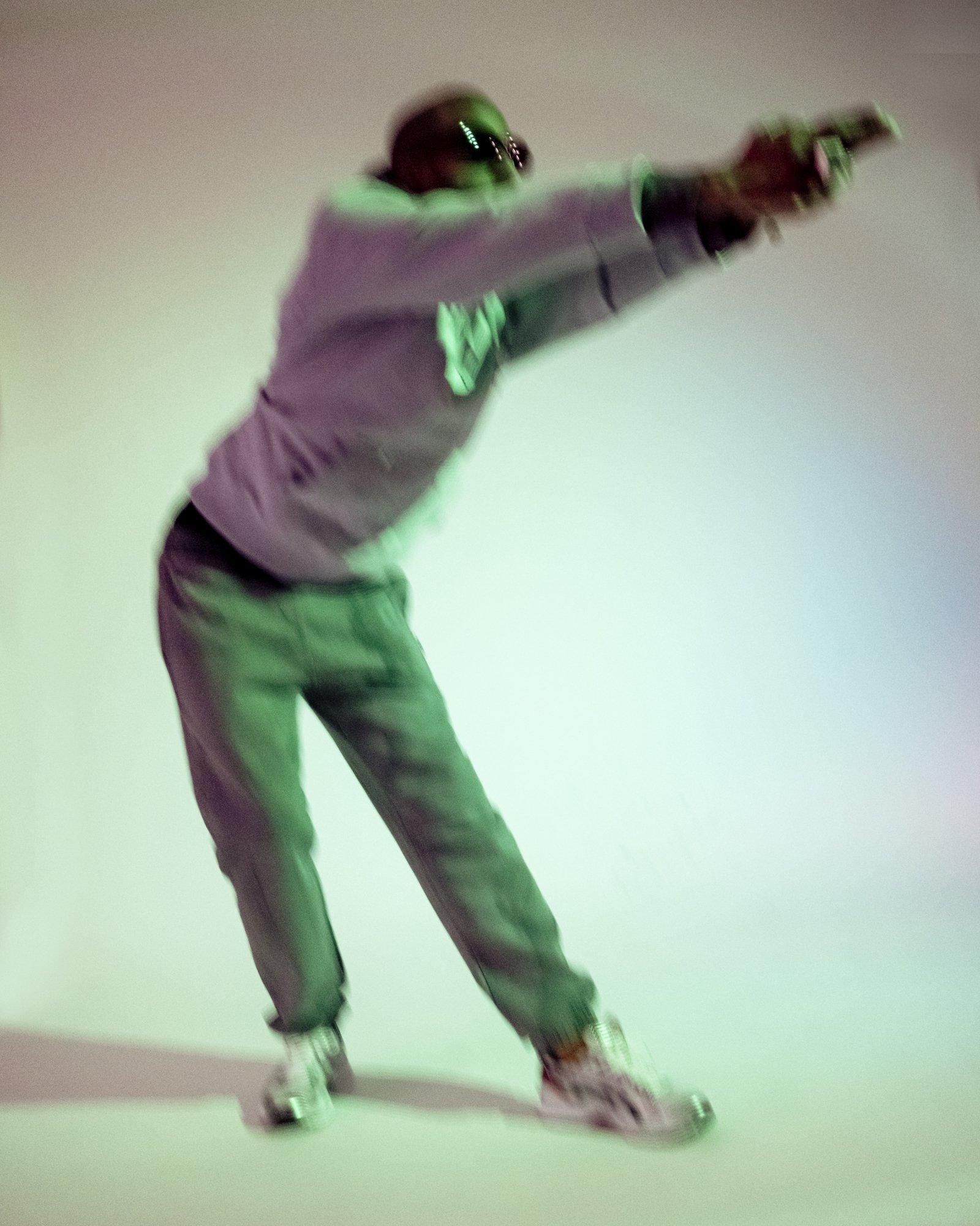 Blurry photo of a model posing for Visual Installment 9.