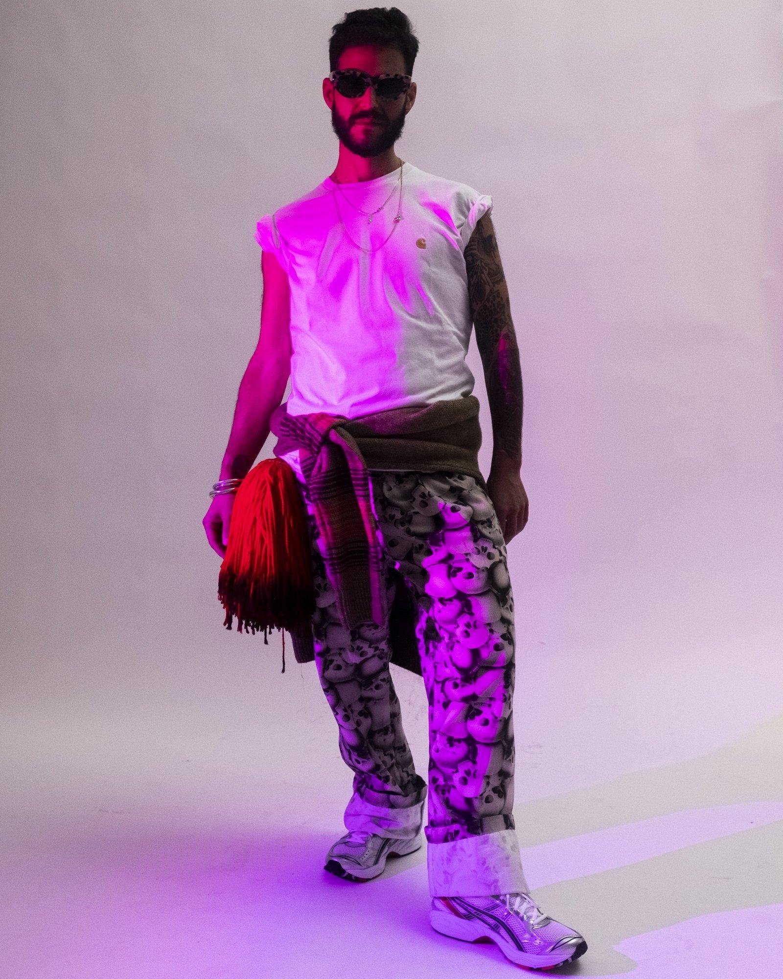 MAle Model posing for Visual Instalment 9 in pink lighting.