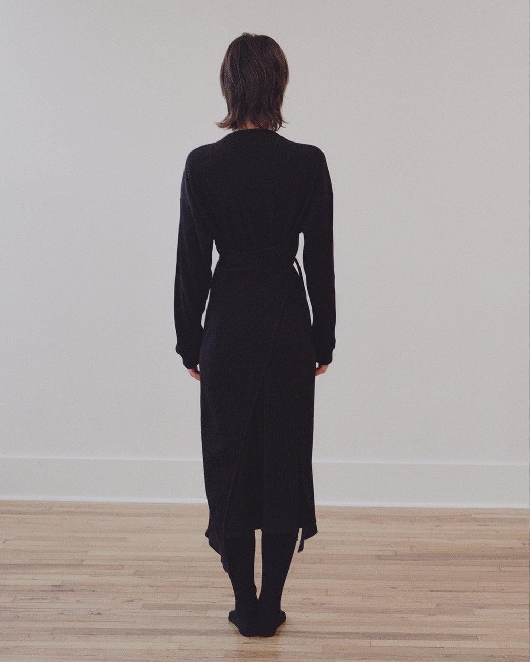 Model wearing the Baserange Shaw Kaftan in black from the back.