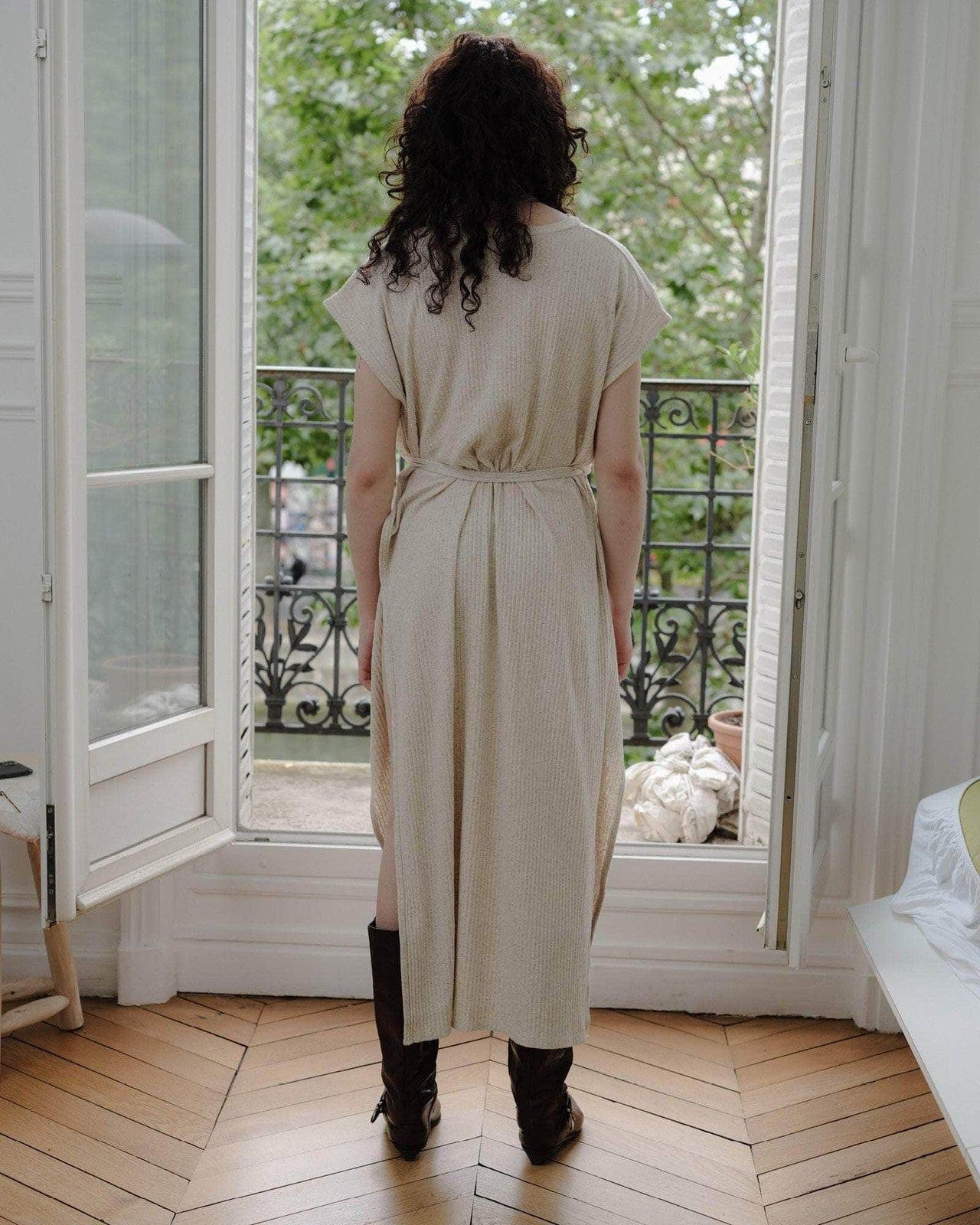 Model wearing the Baserange Shaw Sleeveless Dress from the back.