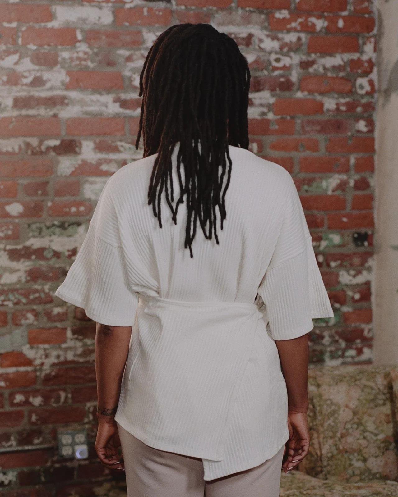 Model wearing the Baserange Shaw Tee in off-from the back.