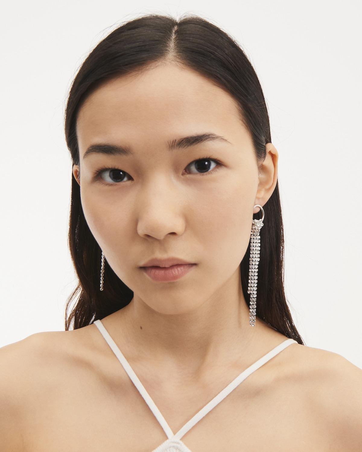 Front view of a person wearing the Justine Clenquet Shanon Earrings.