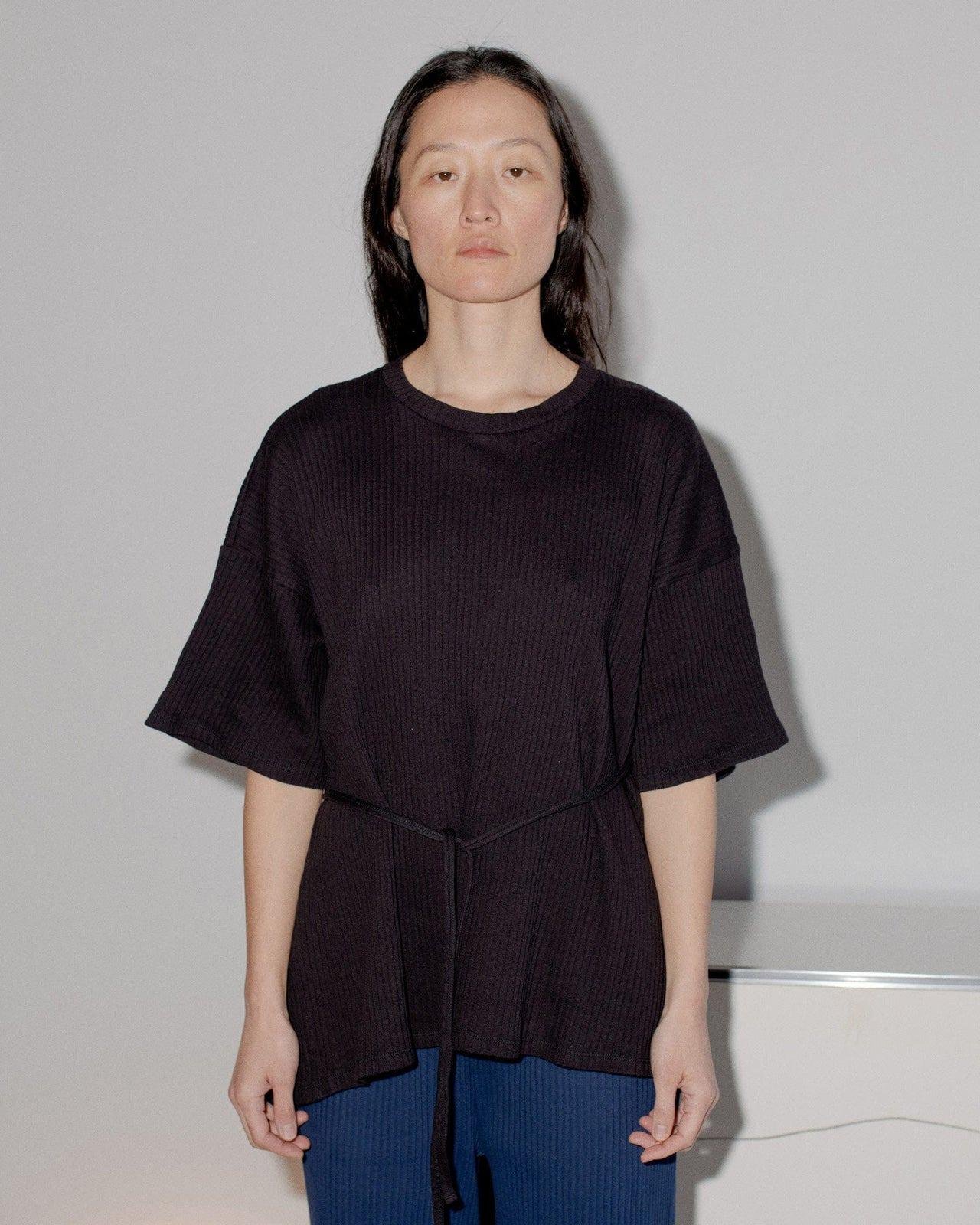 Person wearing the Baserange Shaw Tee from the front.