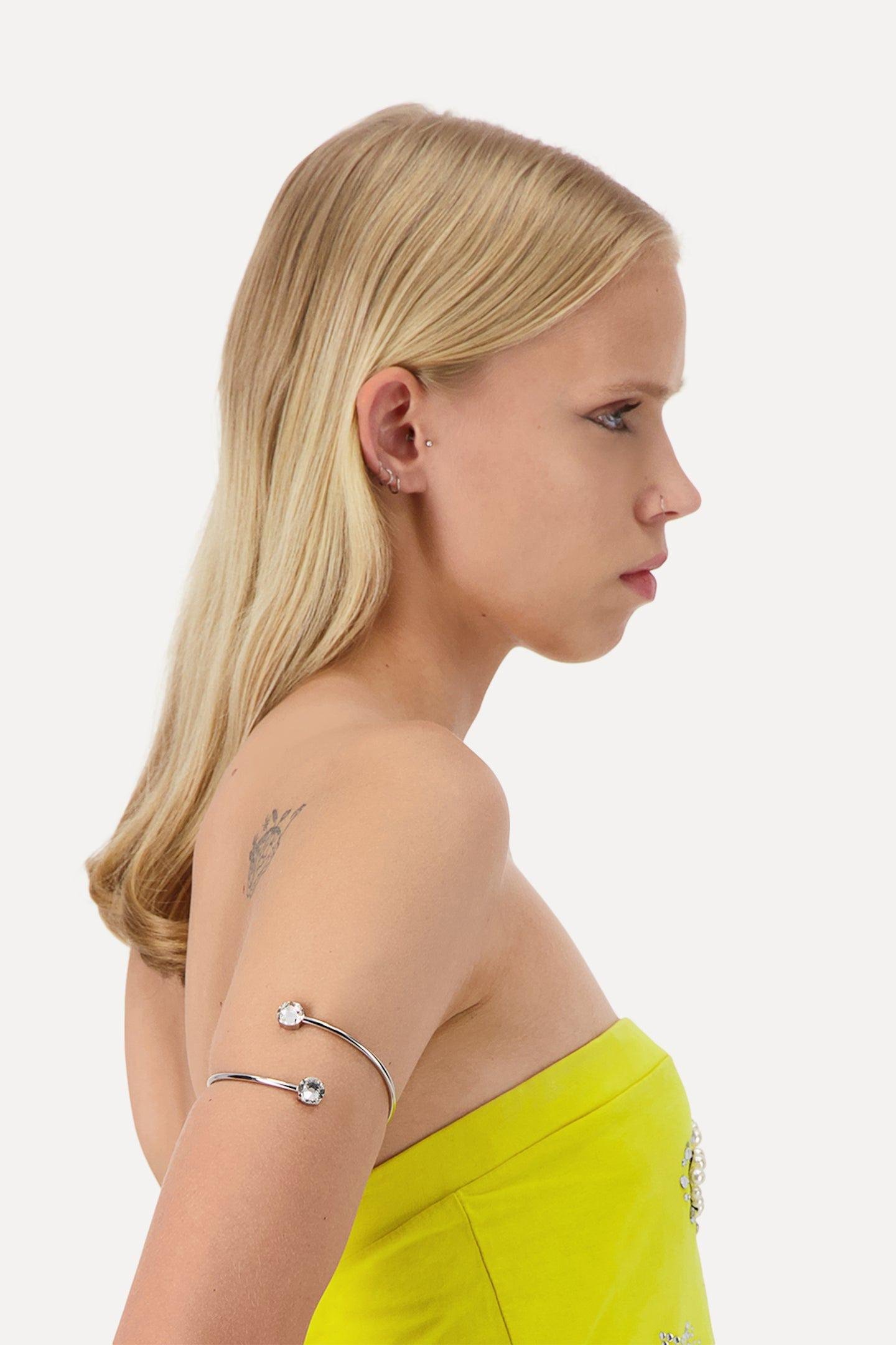 A person wearing the Justine Clenquet Rae Arm Cuff