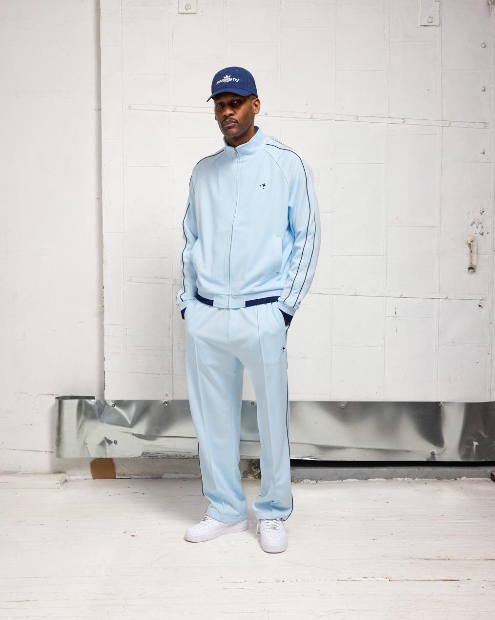 Man wearing a baby blue tracksuit for the Awake NY lookbook Spring24