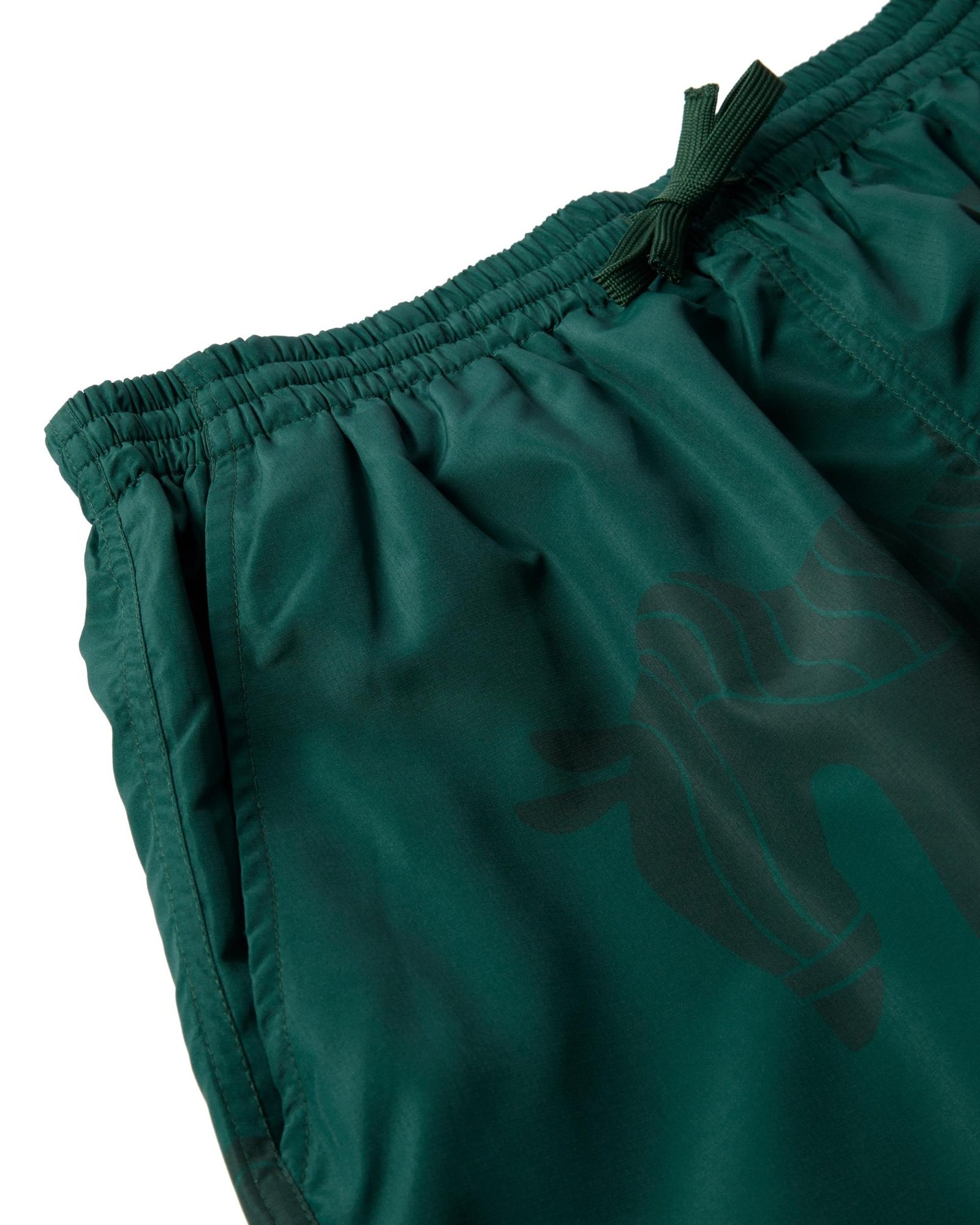 Detail of the by Parra Horse Shorts in Green from the front.