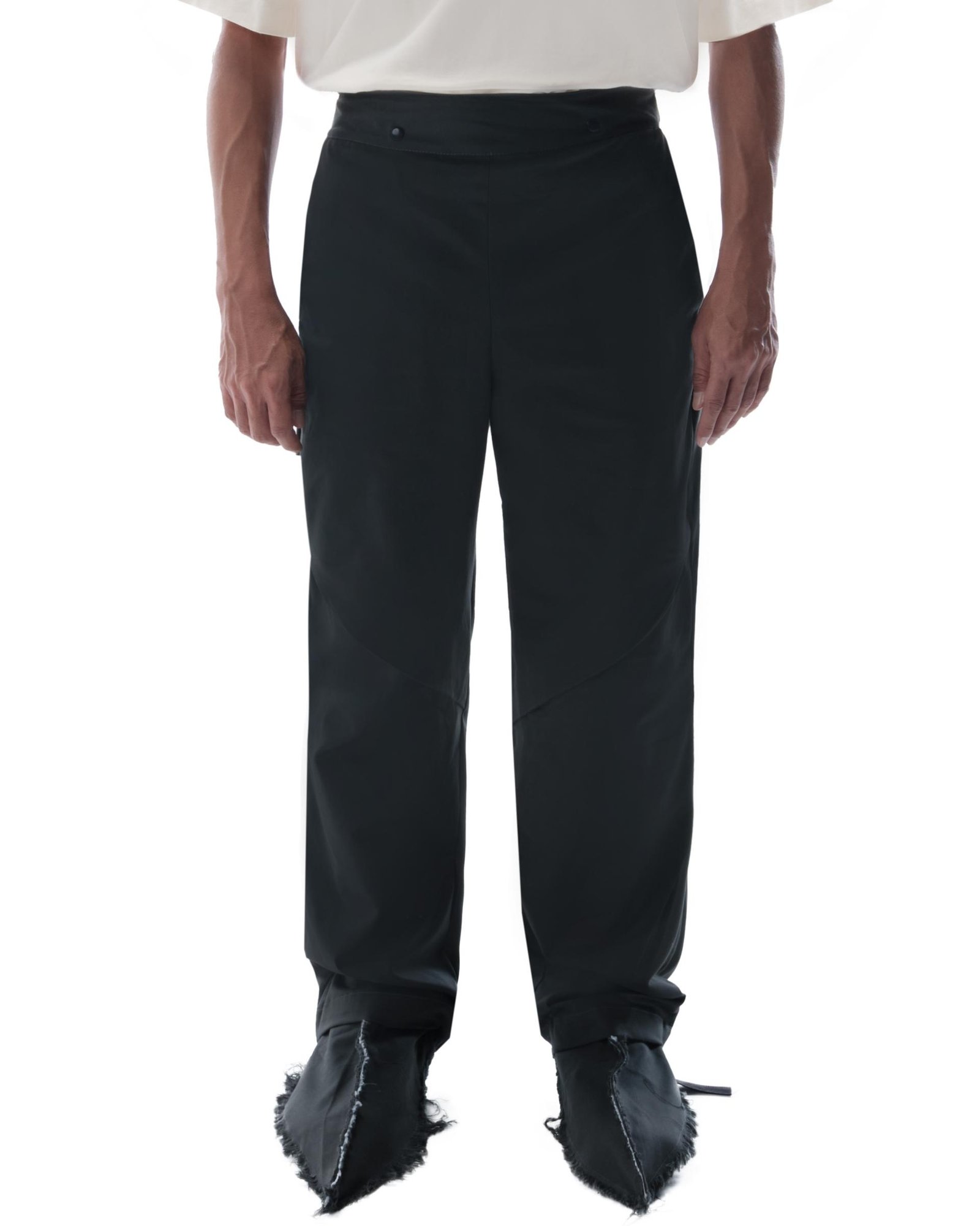 Close view from the front of a person wearing the Flamel Pants in Dark Grey.