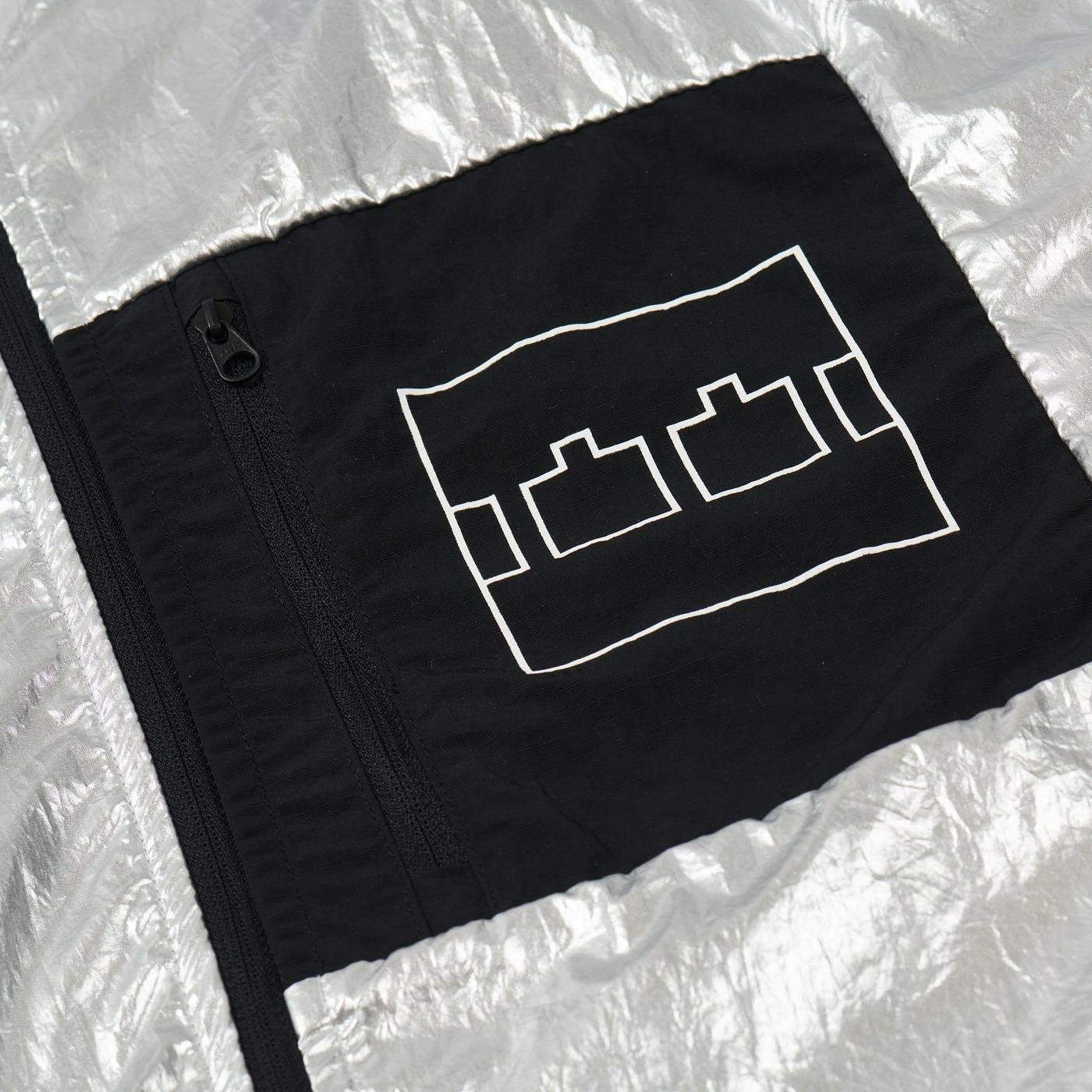 The Trilogy Tapes Lightweight Jacket pocket detail with logo.