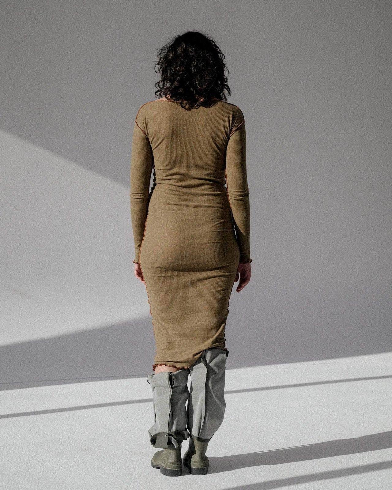 Person wearing the Baserange Vein Long Sleeve Dress Jade from the back.