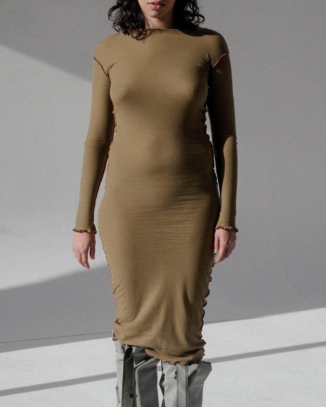 Close view of a person wearing the Baserange Vein Long Sleeve Dress Jade from the front.