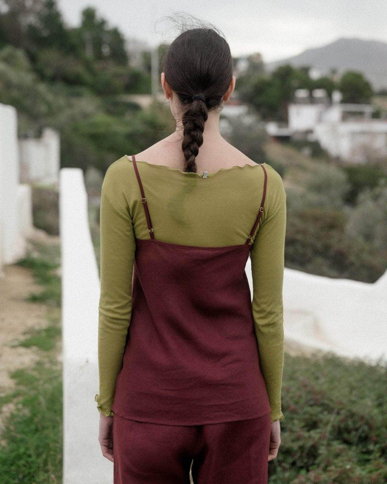 Person wearing the Baserange Dydine Top Burgundy from the back.