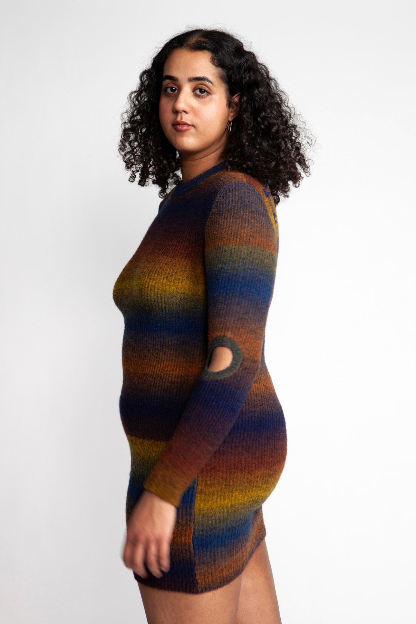 Person wearing the Aries Boucle Space Dye Holey Dress from the side