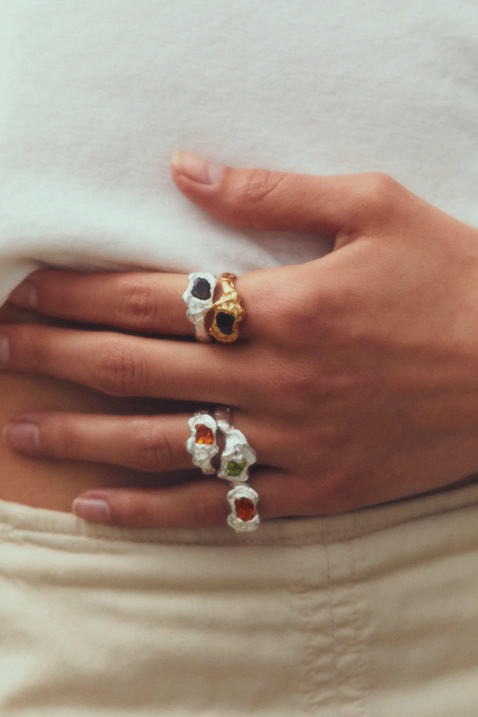 Several Simuero Ola Orange Rings on the hand