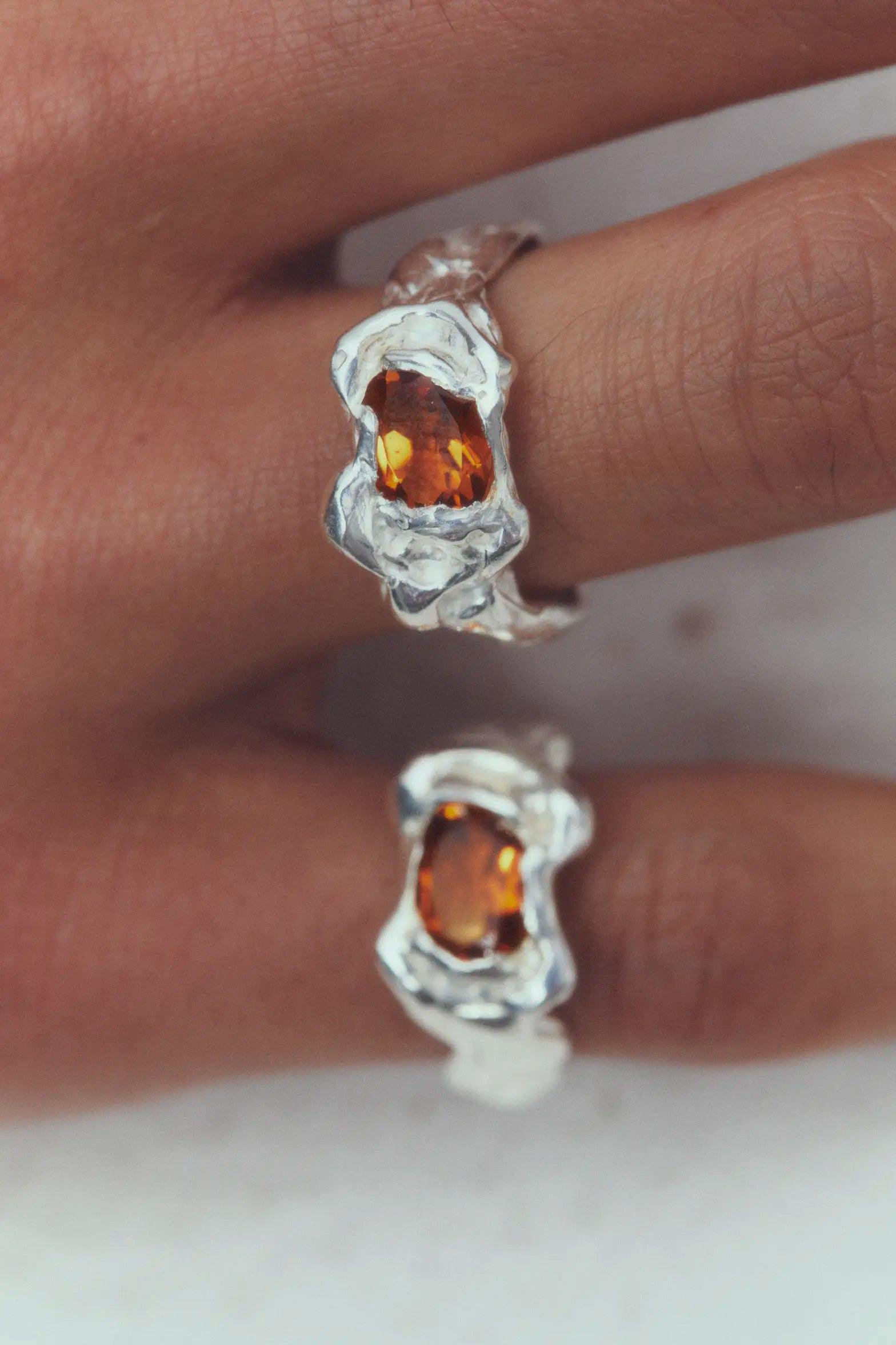 Two Simuero Ola Orange Rings on the hand