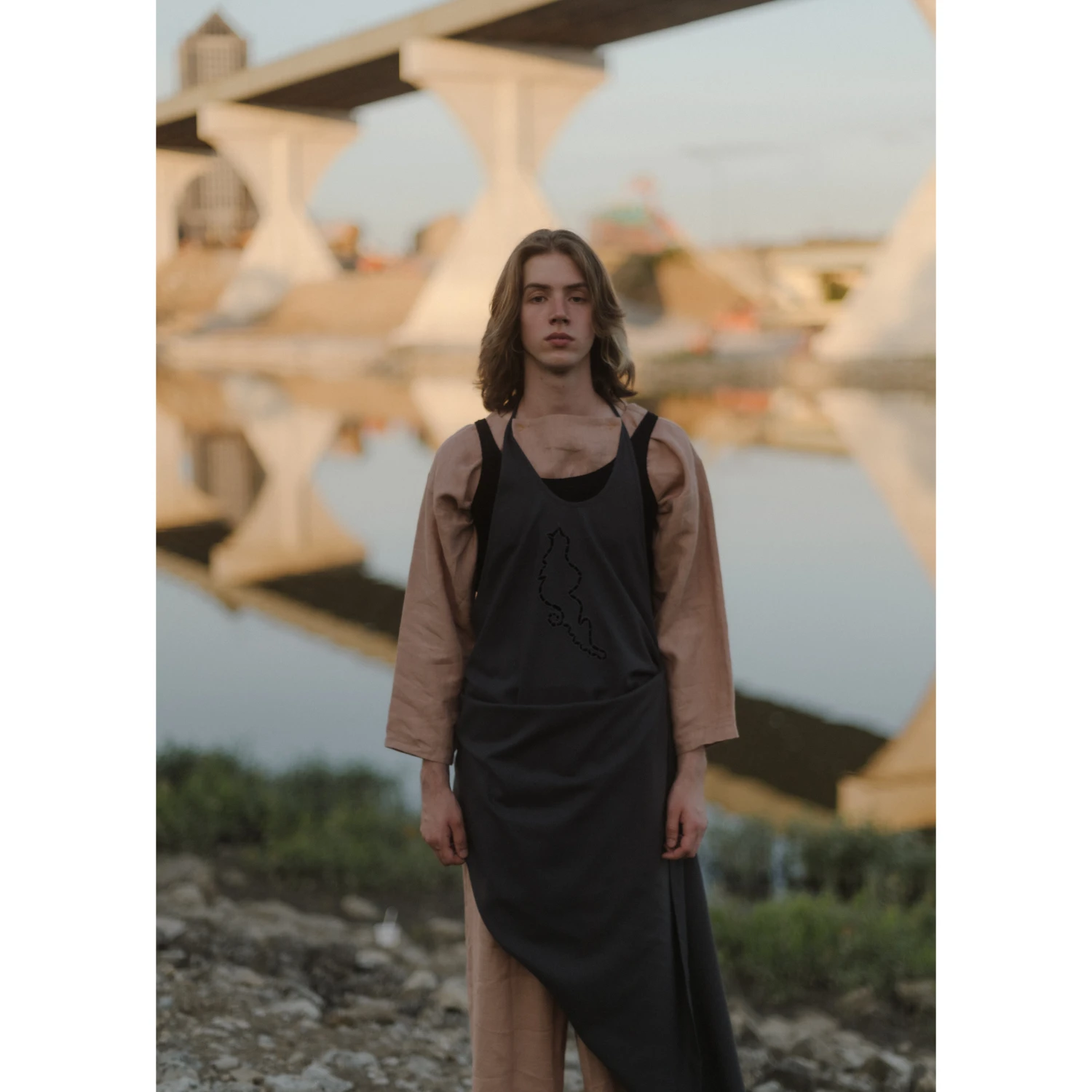 Baserange Lei Apron Dress Bridge Grey front view on model in an outdoor setting