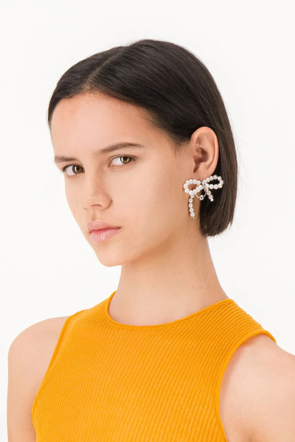 Justine Clenquet Sheena Earrings on model in a white background