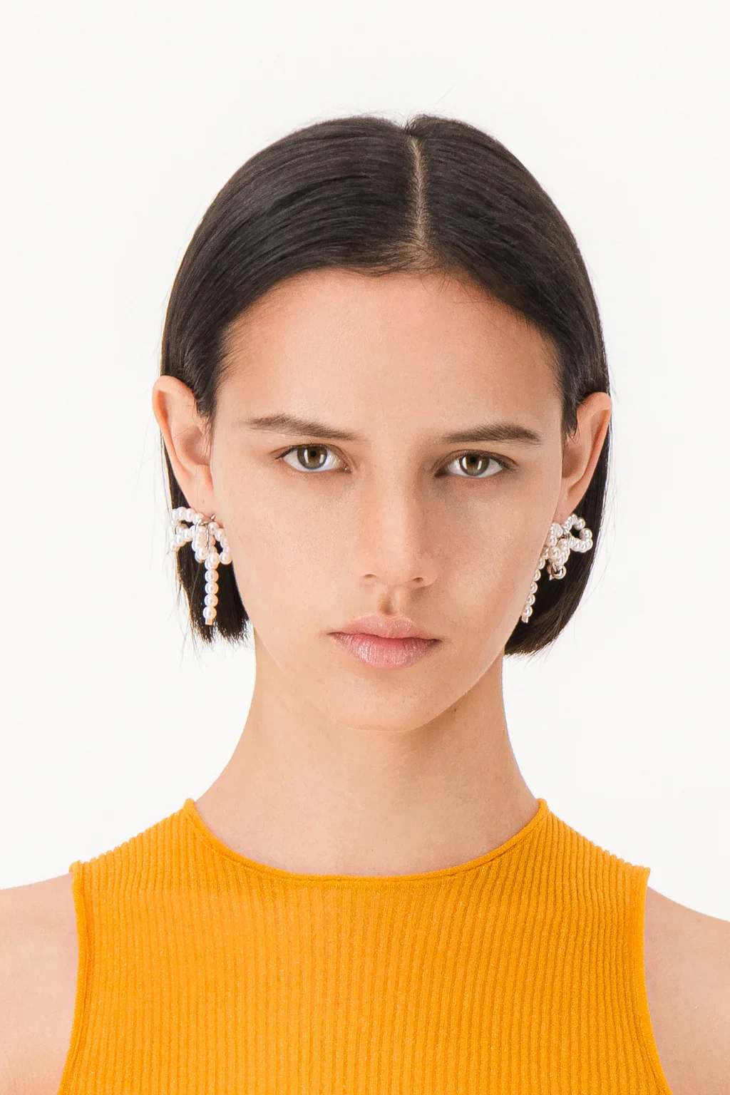 Justine Clenquet Sheena Earrings on model in a white background