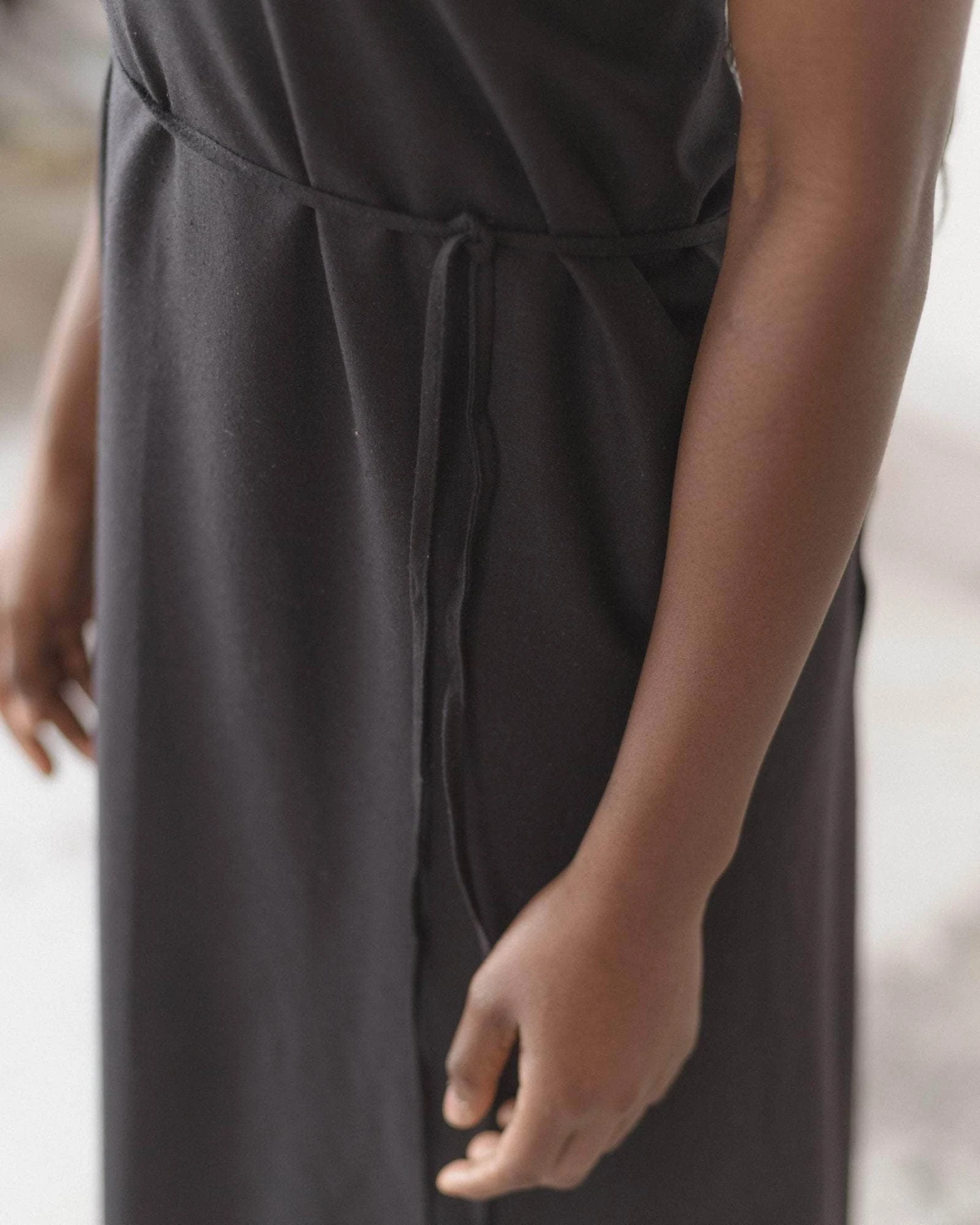 Baserange Apron Dress Black waist detail on model