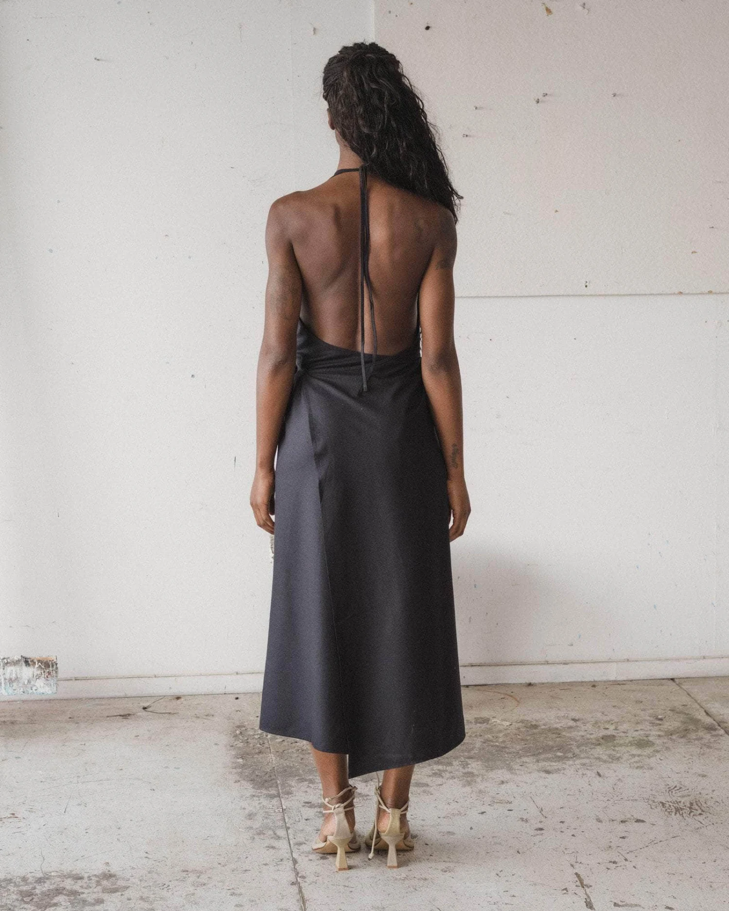 Baserange Apron Dress Black back view on model