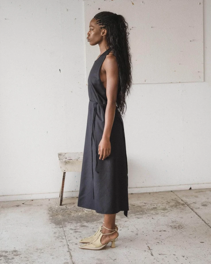 Baserange Apron Dress Black side view on model