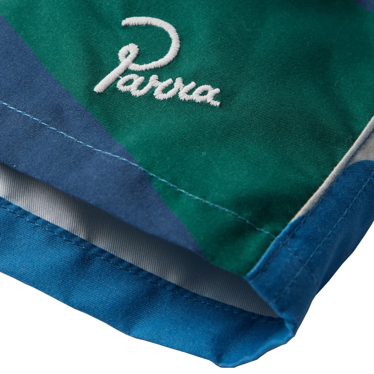 The Festival Fence Swim Shorts front view logo detail in a white background