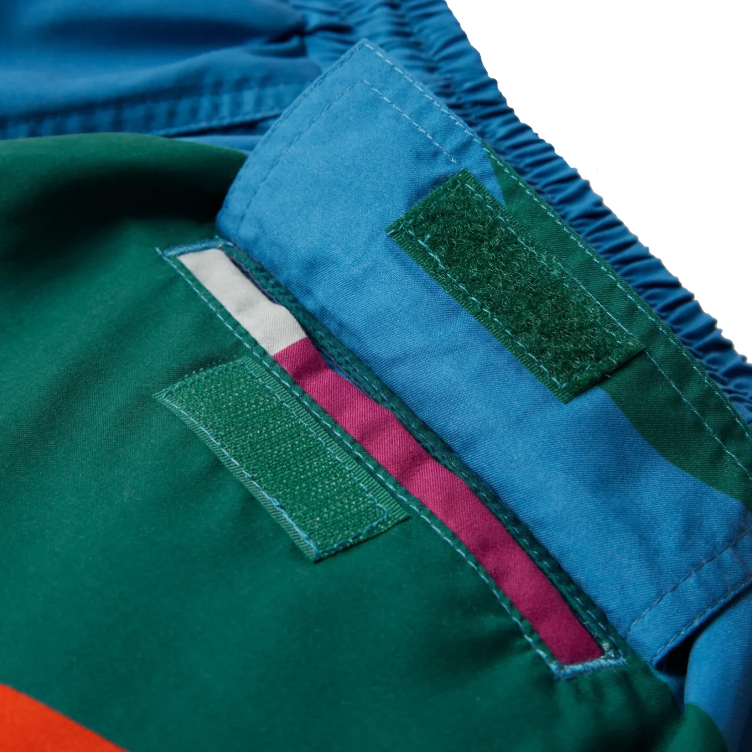The Festival Fence Swim Shorts back view pocket detail in a white background