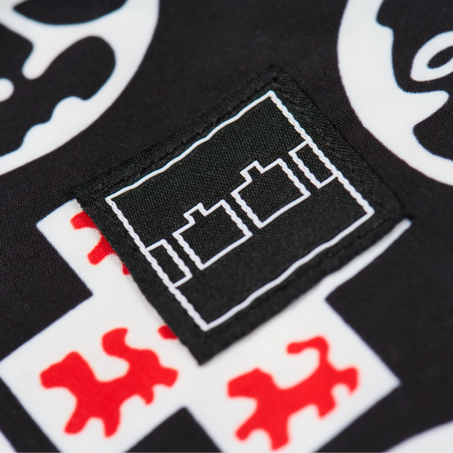 The Trilogy Tapes Crosshead Swimshorts front view logo detail