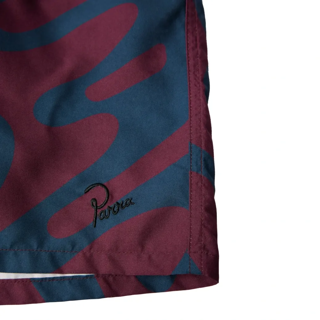 by Parra Splashed Swim Shorts front view embroidery detail in a white background