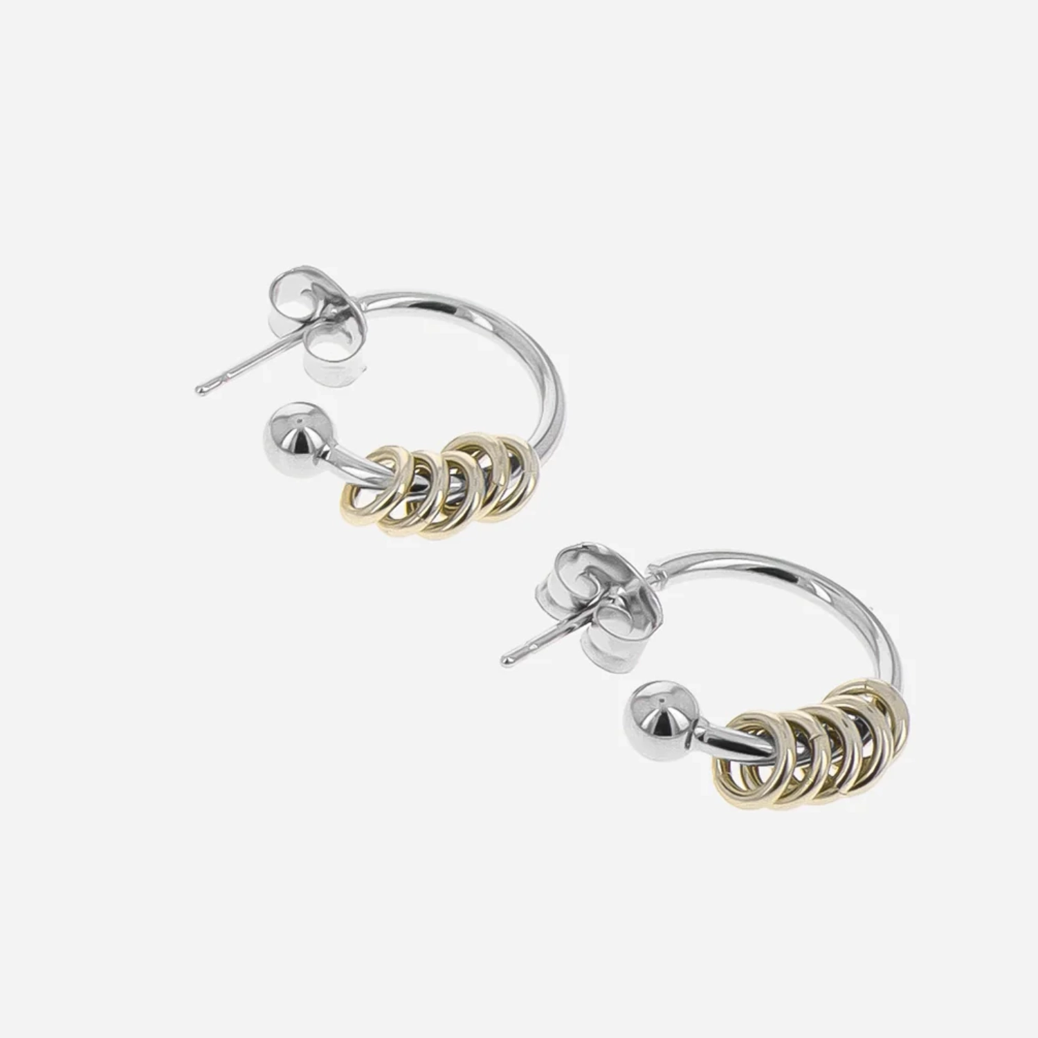 Justine Clenquet Gloria Hoops Gold/Palladium in a grey background