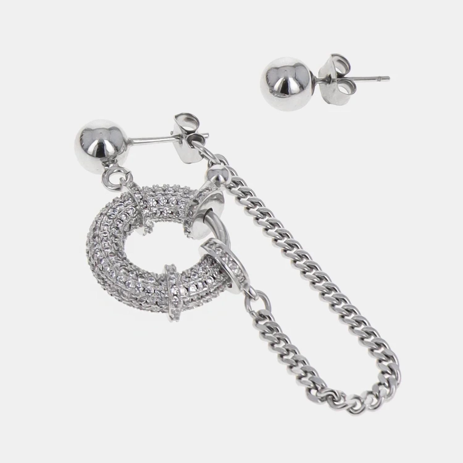 Justine Clenquet Hope Earrings Palladium in a grey background