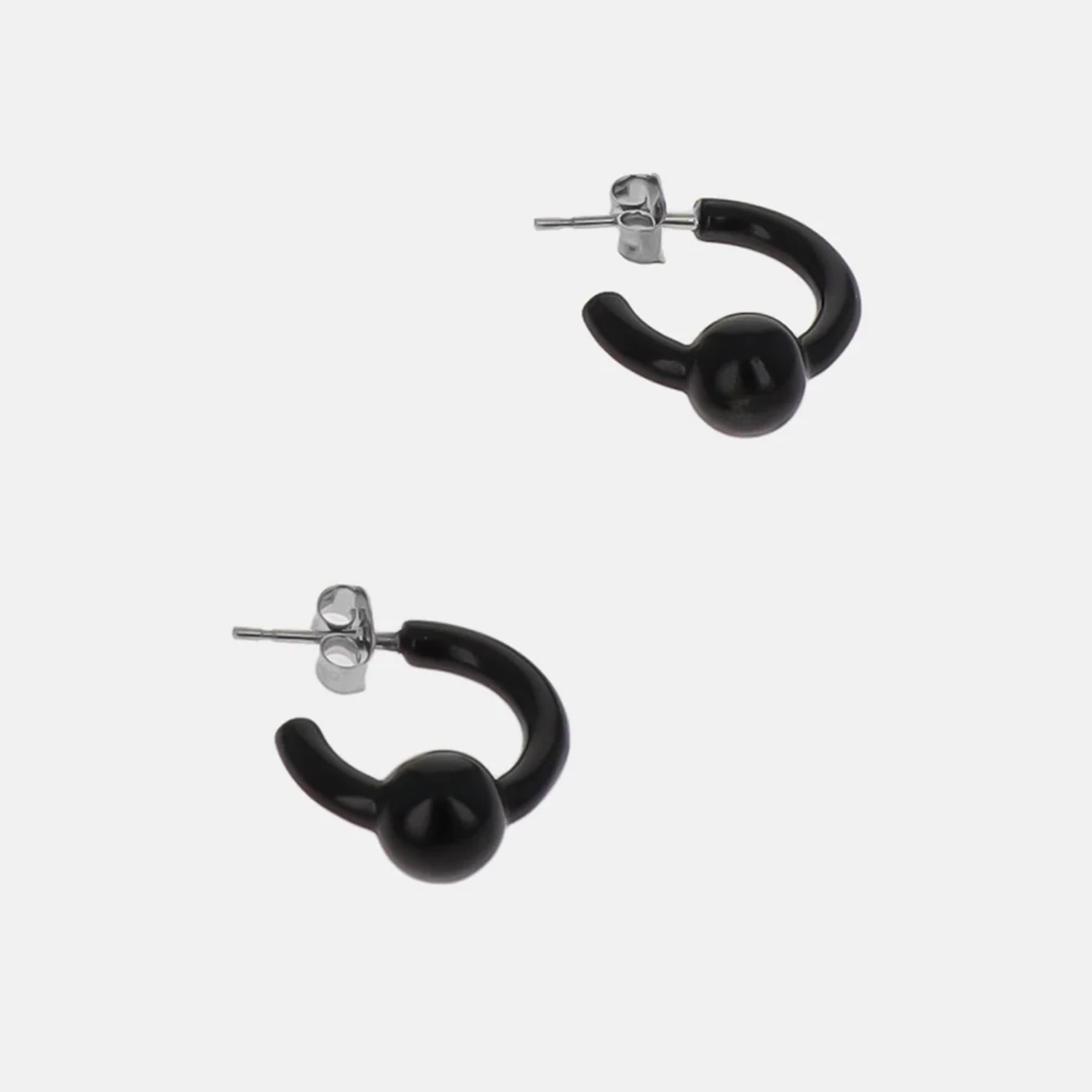 Justine Clenquet Sam Black Earrings side view in a grey background