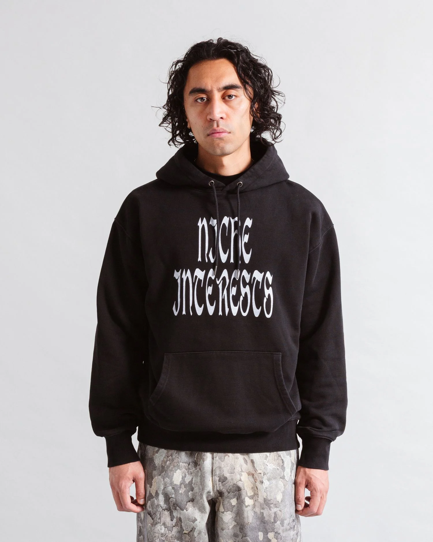 Heresy Niche Interests Hoodie Black front view on model