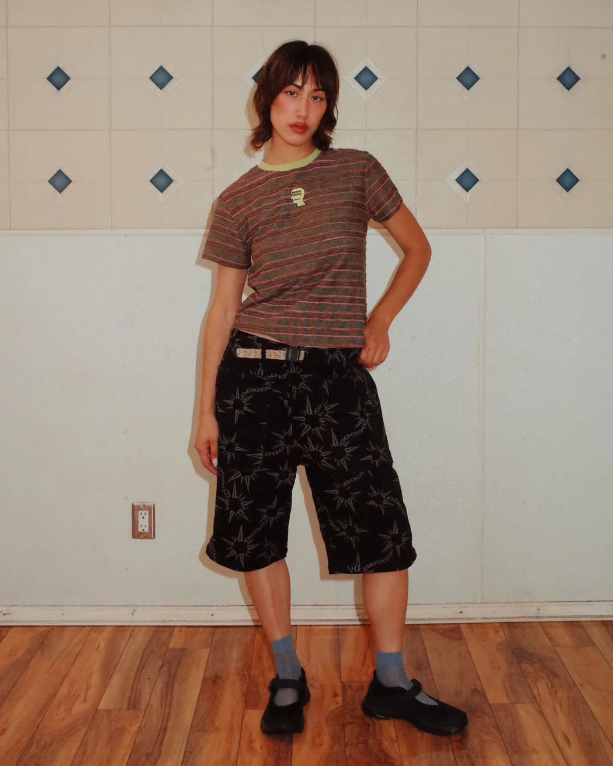 The Brain Dead Pudu Stripe Baby T-Shirt Green front view on model