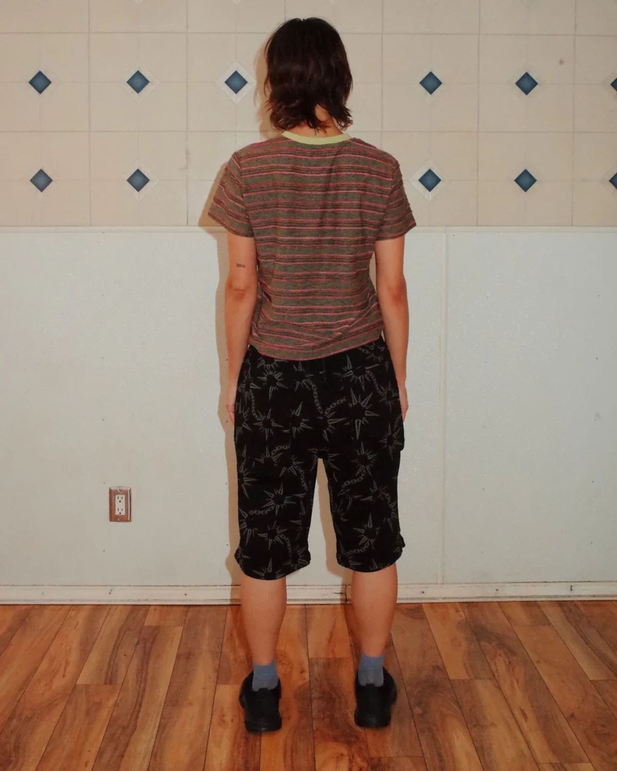 The Brain Dead Pudu Stripe Baby T-Shirt Green back view on model