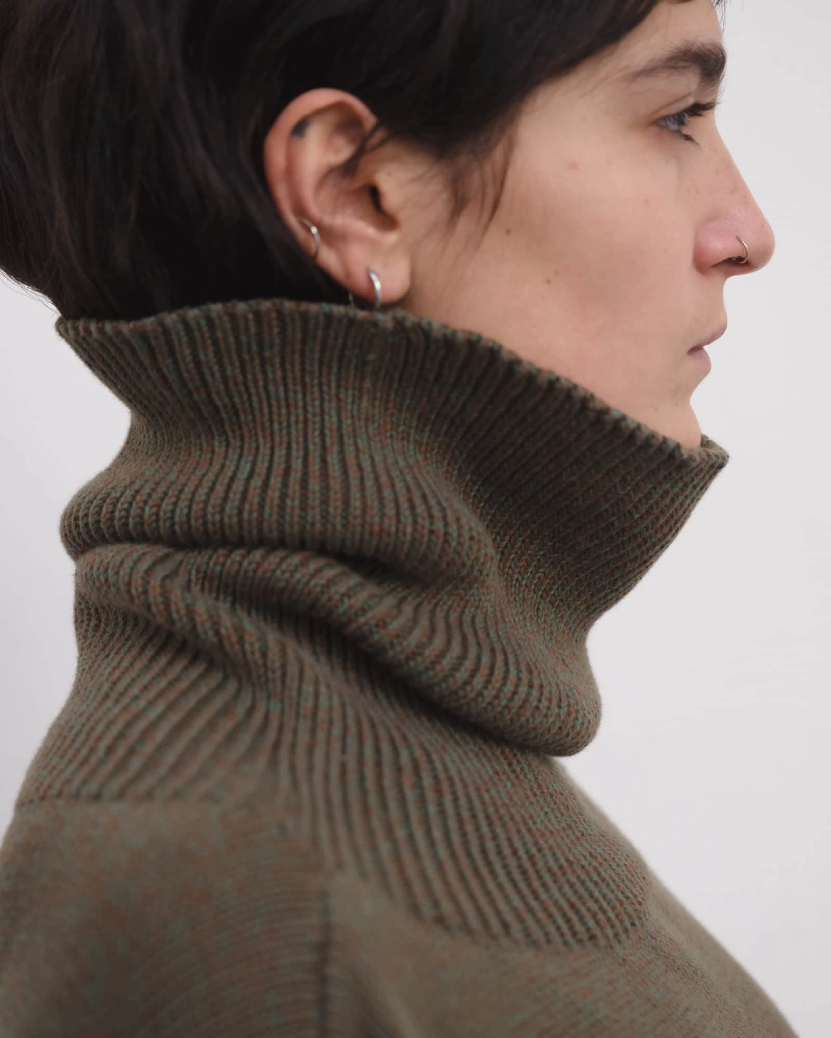 Baserange Calla Turtleneck Green Brown Melange detail on model