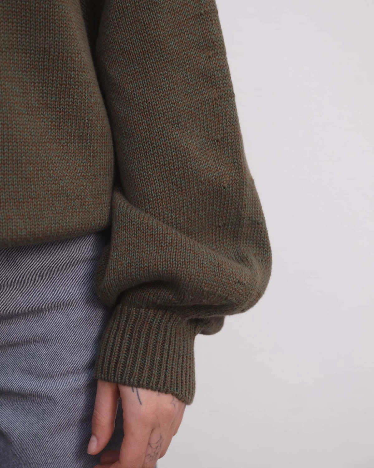 Baserange Calla Turtleneck Green Brown Melange detail on model