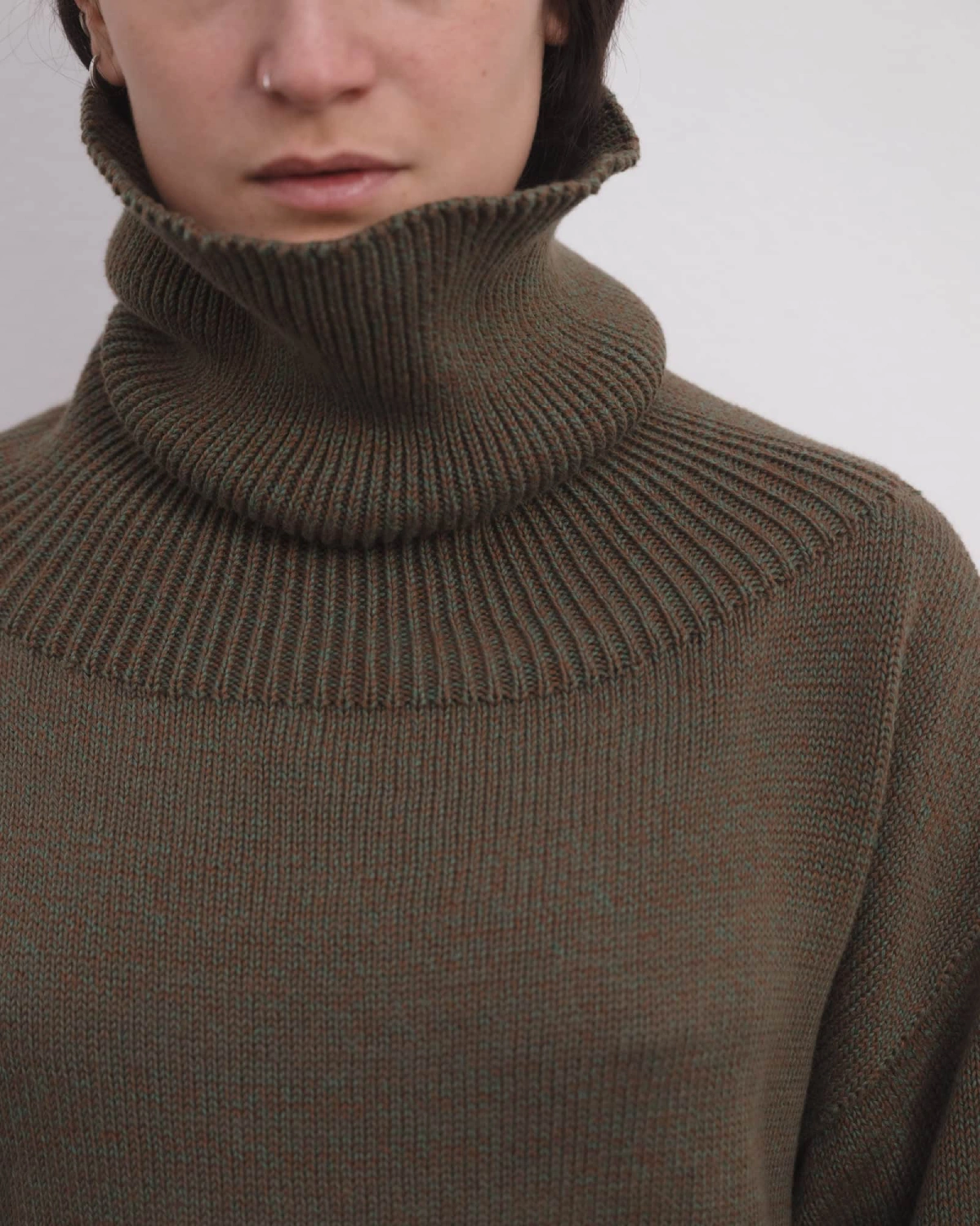 Baserange Calla Turtleneck Green Brown Melange detail on model